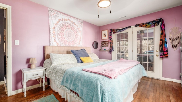 bedroom with baseboards, visible vents, ceiling fan, hardwood / wood-style flooring, and access to outside