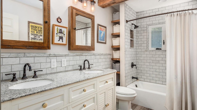 bathroom with a sink, toilet, shower / bath combo, and double vanity