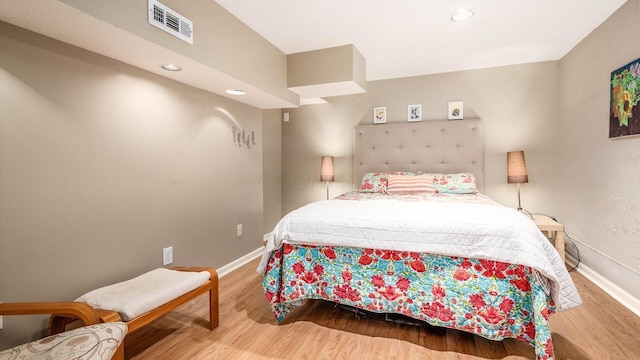 bedroom featuring recessed lighting, visible vents, baseboards, and wood finished floors