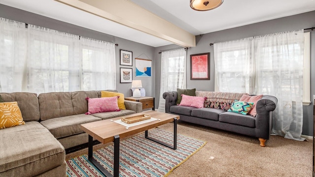 living room featuring beamed ceiling and carpet