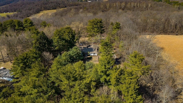 drone / aerial view featuring a wooded view