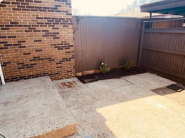 view of patio / terrace featuring fence