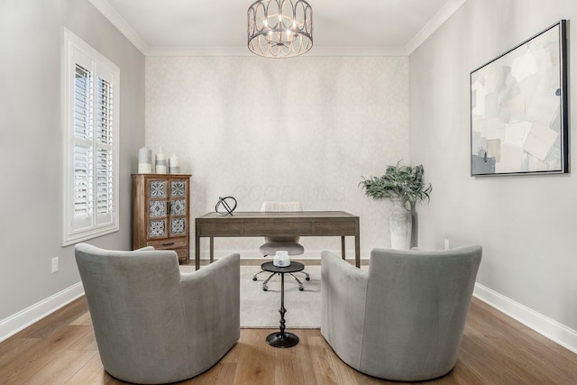 sitting room with baseboards, a notable chandelier, wood finished floors, and crown molding