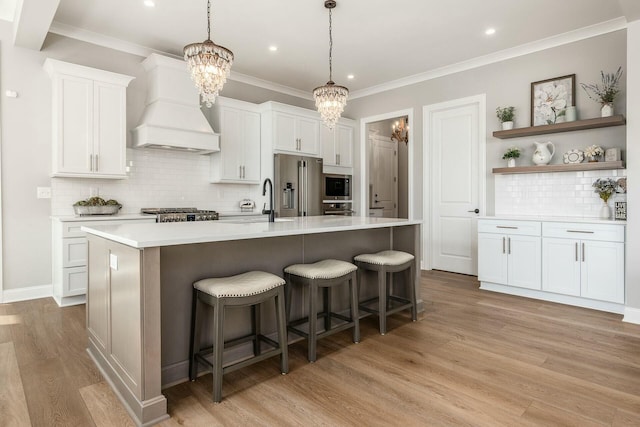 kitchen with premium range hood, open shelves, a kitchen breakfast bar, stainless steel appliances, and light countertops