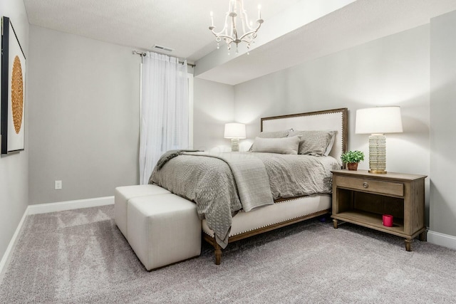 bedroom with visible vents, a notable chandelier, carpet, and baseboards