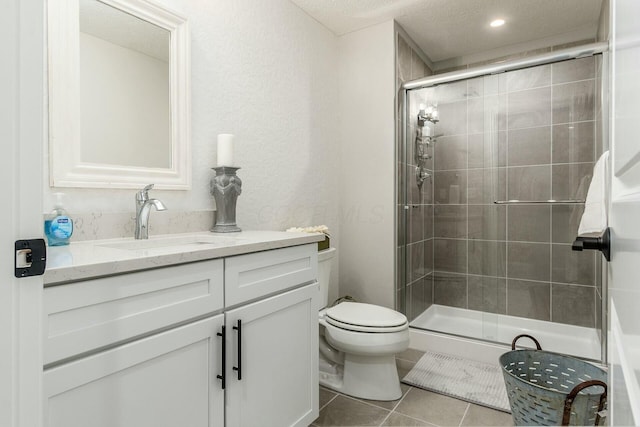 bathroom with tile patterned flooring, toilet, a stall shower, a textured ceiling, and vanity