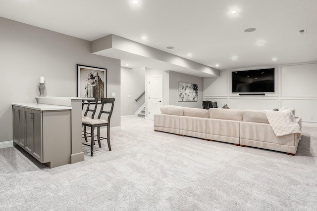 living room with stairway, recessed lighting, light colored carpet, and visible vents