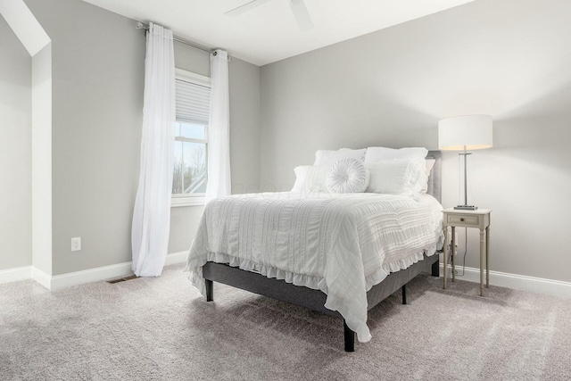 carpeted bedroom with visible vents, baseboards, and ceiling fan