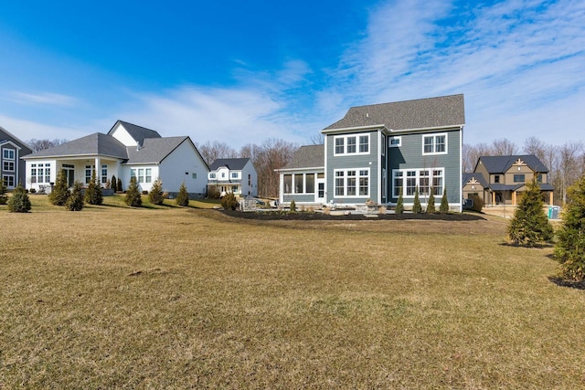 rear view of property featuring a yard