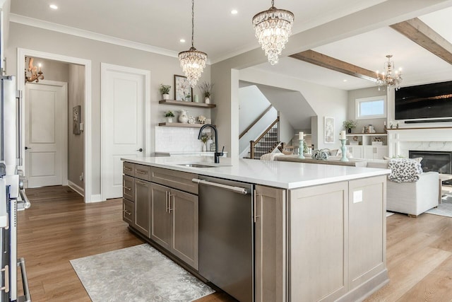 kitchen featuring a sink, light wood-type flooring, dishwasher, and a chandelier