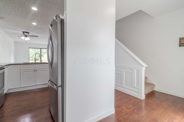 kitchen featuring a textured ceiling, dark wood-style floors, white cabinetry, recessed lighting, and freestanding refrigerator