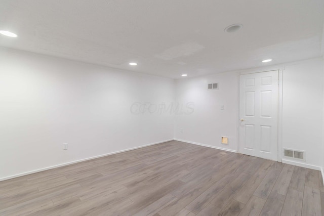 spare room featuring baseboards, recessed lighting, visible vents, and light wood-type flooring