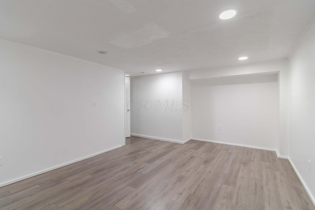 unfurnished room featuring recessed lighting, baseboards, and light wood finished floors