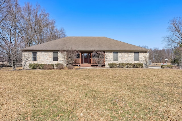 single story home with stone siding, covered porch, and a front lawn