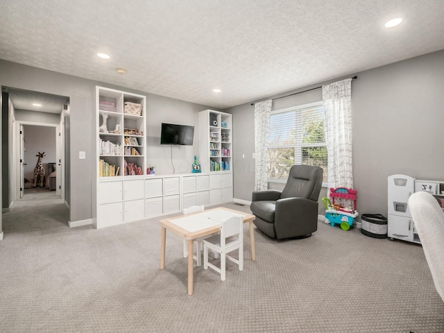 carpeted living room with recessed lighting, baseboards, and a textured ceiling