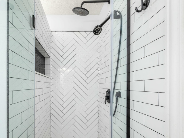 full bath featuring a textured ceiling and a stall shower