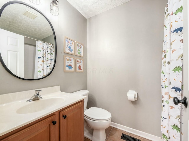 full bath with vanity, visible vents, tile patterned flooring, a textured ceiling, and toilet