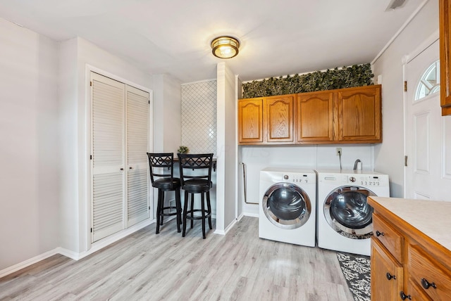 336 E Plum St, Westerville, OH 43081 - laundry area with cabinet space, light wood-style flooring, separate washer and dryer, and baseboards