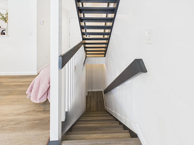 stairs featuring baseboards and wood finished floors