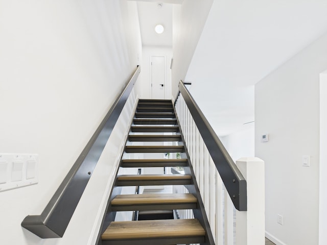 staircase featuring baseboards