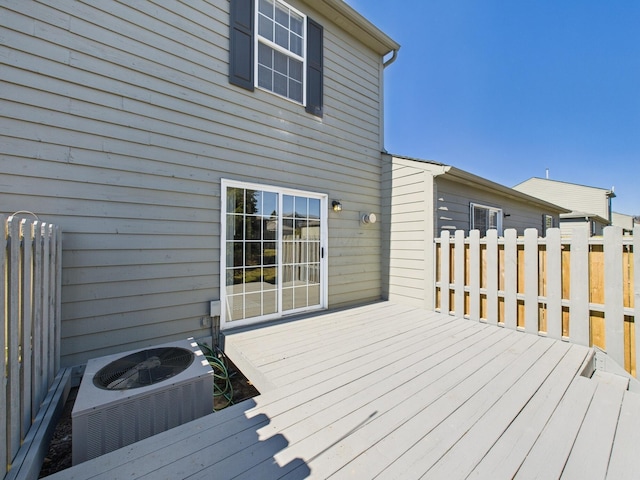 wooden terrace featuring central AC unit and fence