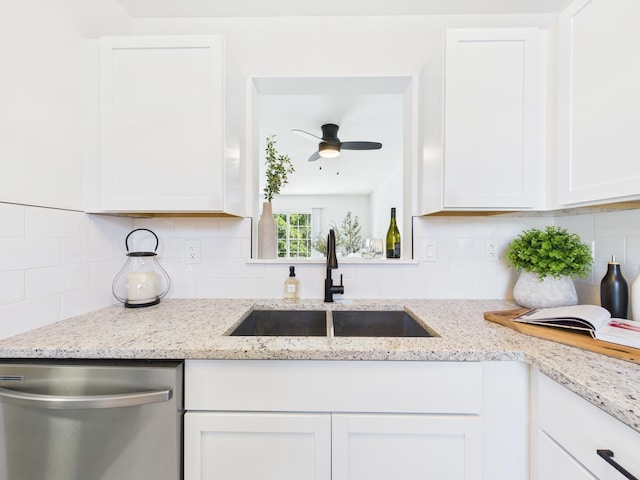 kitchen with dishwasher, white cabinets, tasteful backsplash, and a sink