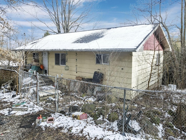 snow covered property featuring fence