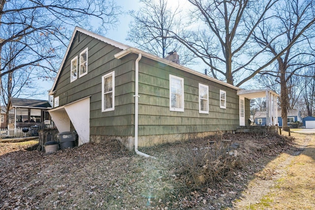 view of property exterior featuring a chimney