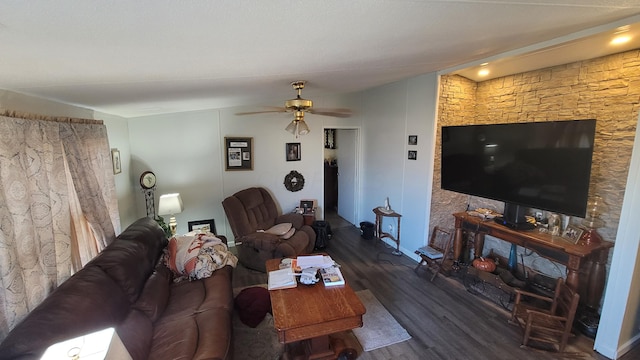 living room with ceiling fan, wood finished floors, and vaulted ceiling