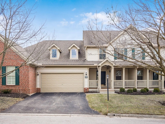 view of front of property with a front lawn, aphalt driveway, a porch, a shingled roof, and a garage