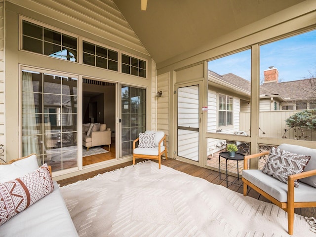 sunroom featuring lofted ceiling