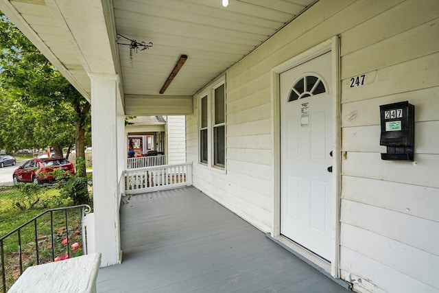 view of exterior entry featuring a porch