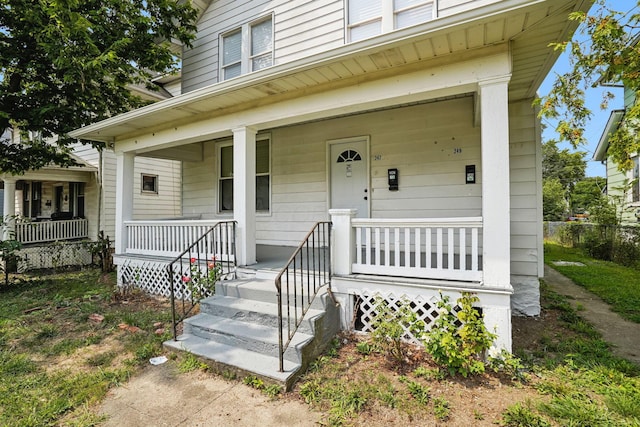 view of exterior entry with a porch