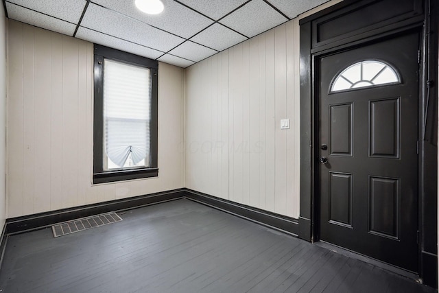 foyer entrance featuring a drop ceiling, visible vents, baseboards, and dark wood-style flooring