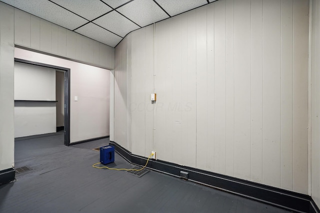 empty room with visible vents, a paneled ceiling, and wood finished floors