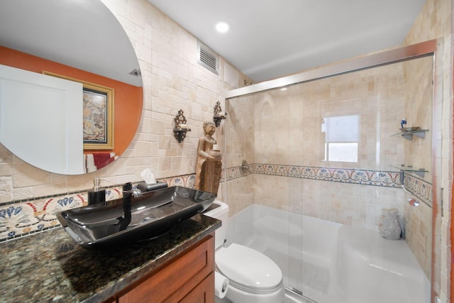 full bathroom featuring visible vents, toilet, a stall shower, and vanity