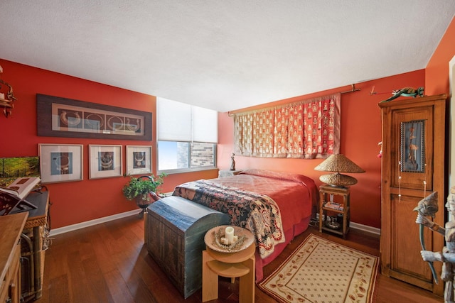 bedroom with hardwood / wood-style floors and baseboards