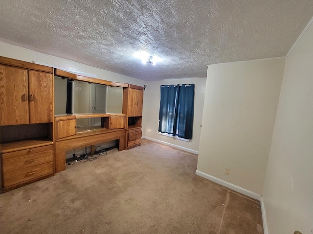 mudroom with baseboards, carpet floors, and a textured ceiling