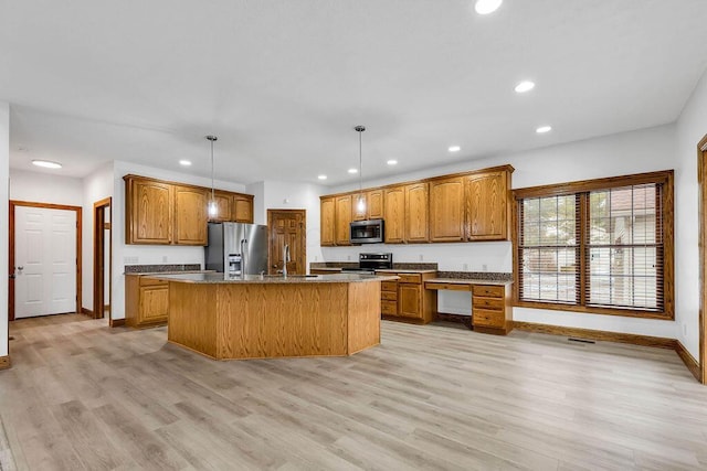 kitchen with recessed lighting, stainless steel appliances, brown cabinets, and light wood-style flooring