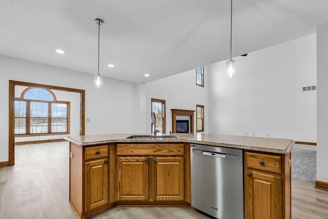 kitchen featuring a sink, plenty of natural light, dishwasher, and open floor plan