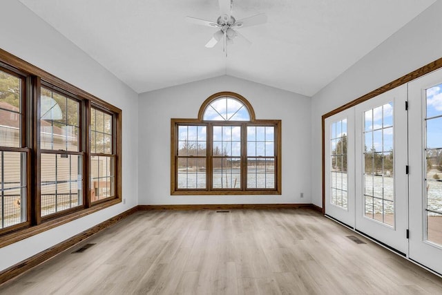 unfurnished sunroom with visible vents, lofted ceiling, and a ceiling fan