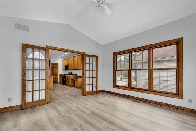 unfurnished living room featuring french doors, lofted ceiling, visible vents, and light wood finished floors