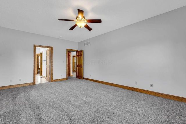 empty room with ceiling fan, baseboards, visible vents, and light carpet