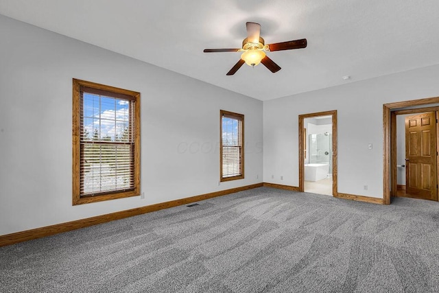 empty room with baseboards, plenty of natural light, and light colored carpet