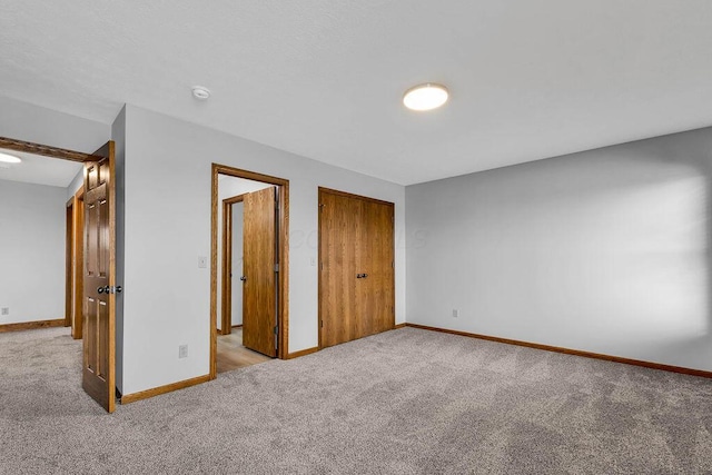 unfurnished bedroom with baseboards and carpet floors