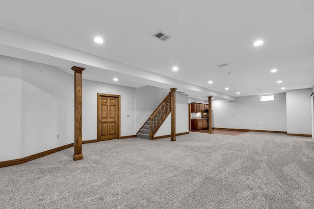 below grade area featuring recessed lighting, visible vents, light carpet, and stairway