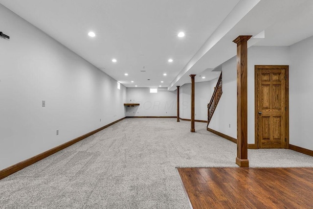 finished basement with stairway, recessed lighting, carpet, and baseboards