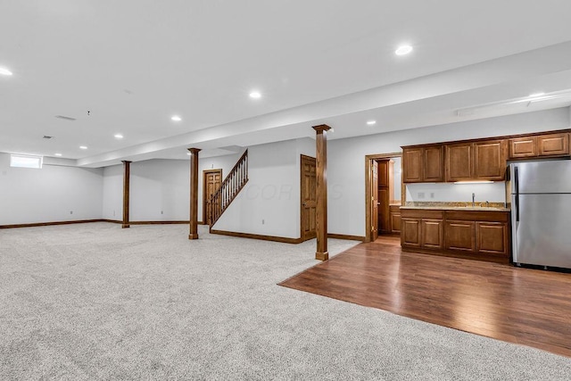 kitchen featuring recessed lighting, light countertops, freestanding refrigerator, and carpet floors