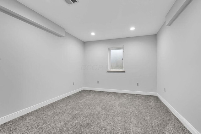 carpeted spare room featuring visible vents, recessed lighting, and baseboards