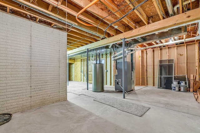 unfinished below grade area with heating unit, water heater, and brick wall